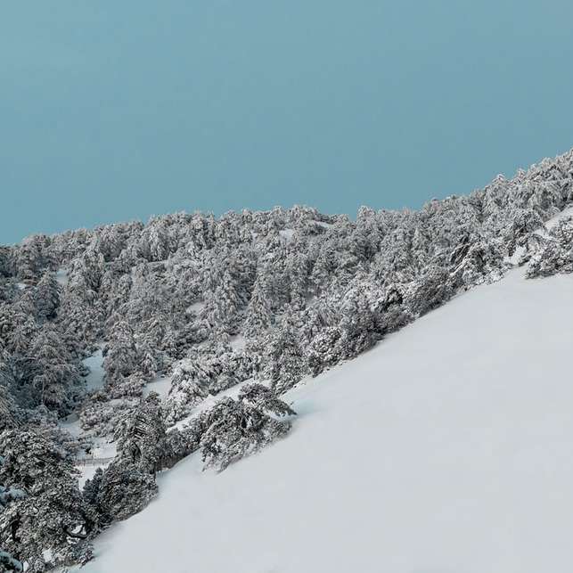 montanha coberta de neve sob céu azul durante o dia puzzle deslizante online