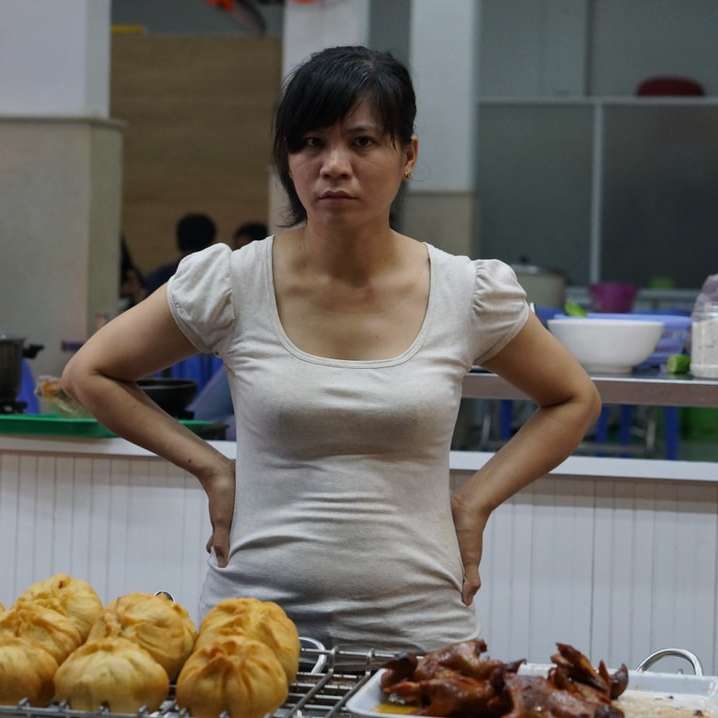 жена в бяла риза с лъжичка, която стои отпред онлайн пъзел