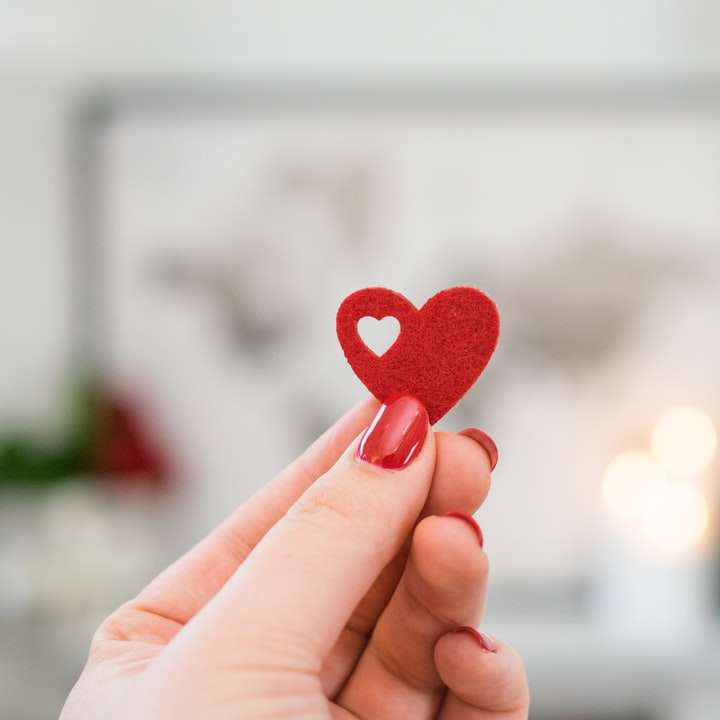 person holding pink heart ornament online puzzle