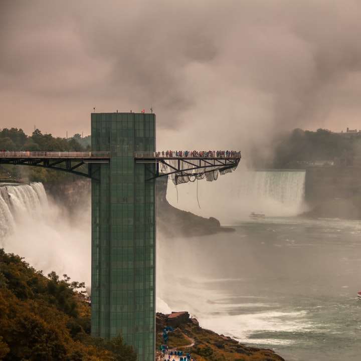 water falls near bridge during daytime online puzzle