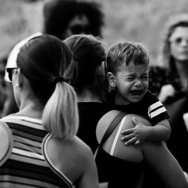 grayscale photo of woman in black tank top carrying child online puzzle