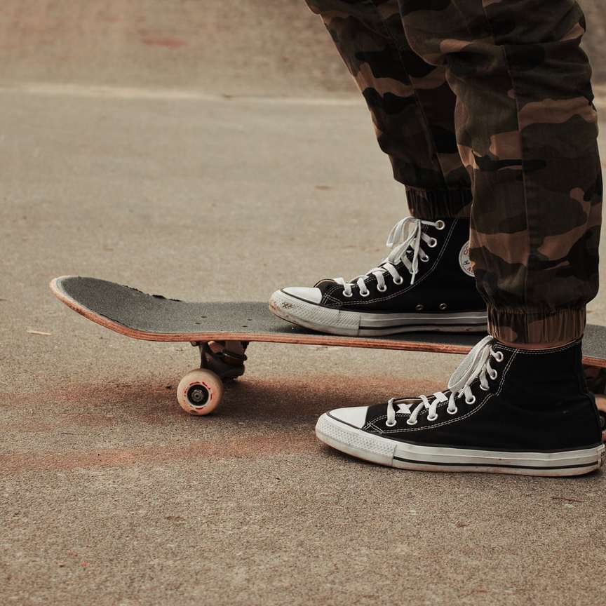 persoană îmbrăcată în adidași Nike, negri și albi, călare pe skateboard alunecare puzzle online