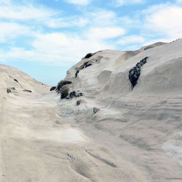 白い雪に覆われた山に立っている人 スライディングパズル・オンライン
