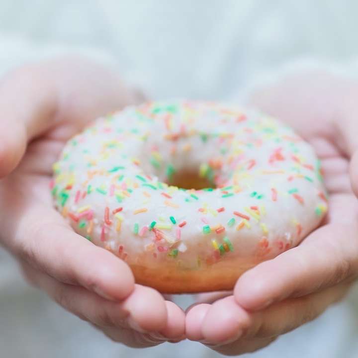person holding doughnut with sprinkles sliding puzzle online