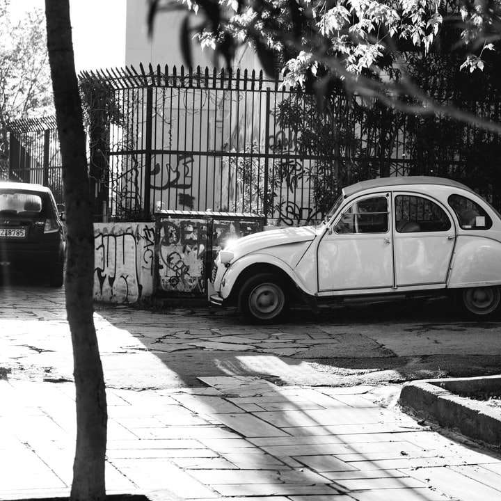 grayscale photo of volkswagen beetle parked on sidewalk sliding puzzle online