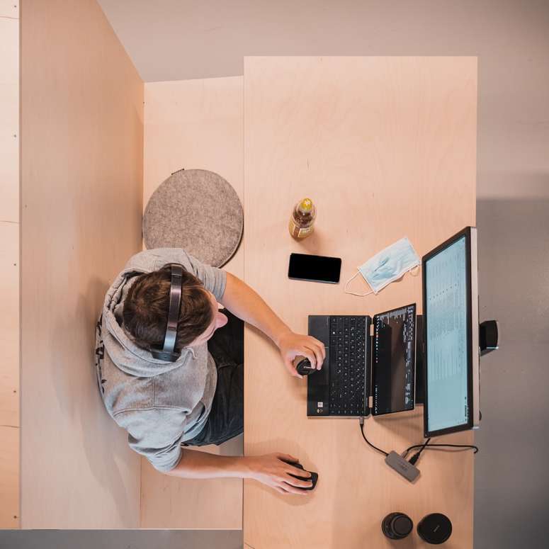 woman in blue shirt sitting on chair using laptop computer sliding puzzle online