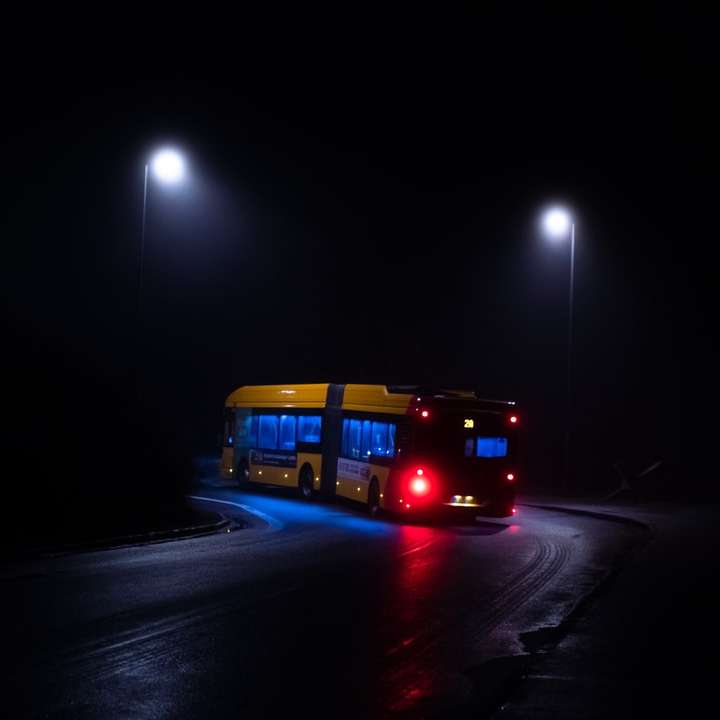 red bus on road during nighttime online puzzle
