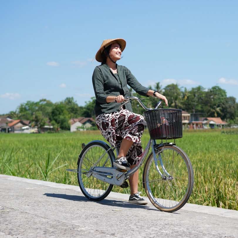 Frau im grauen Langarmhemd, das auf Fahrrad auf Straße fährt Online-Puzzle