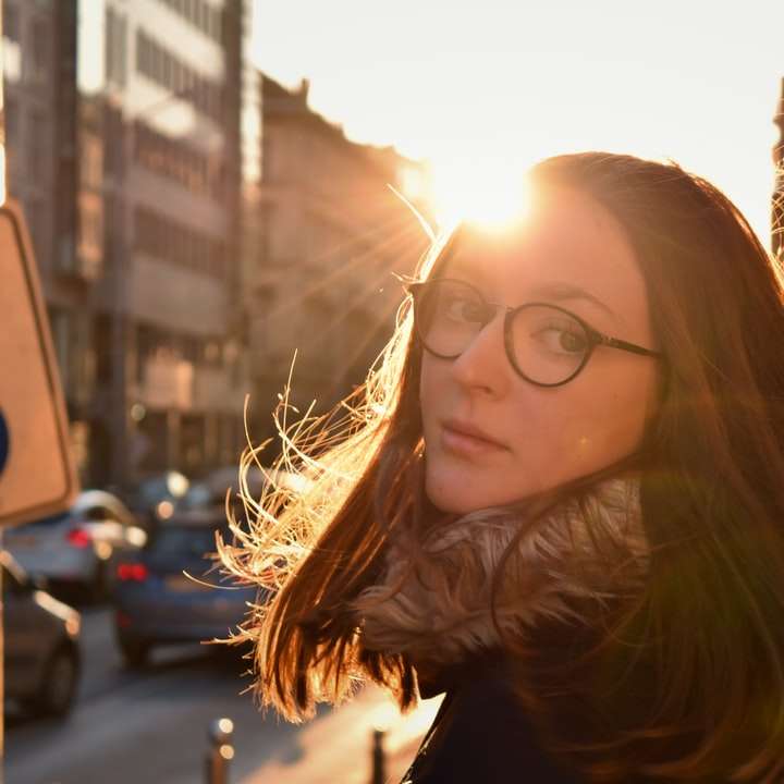 woman in black framed eyeglasses sliding puzzle online