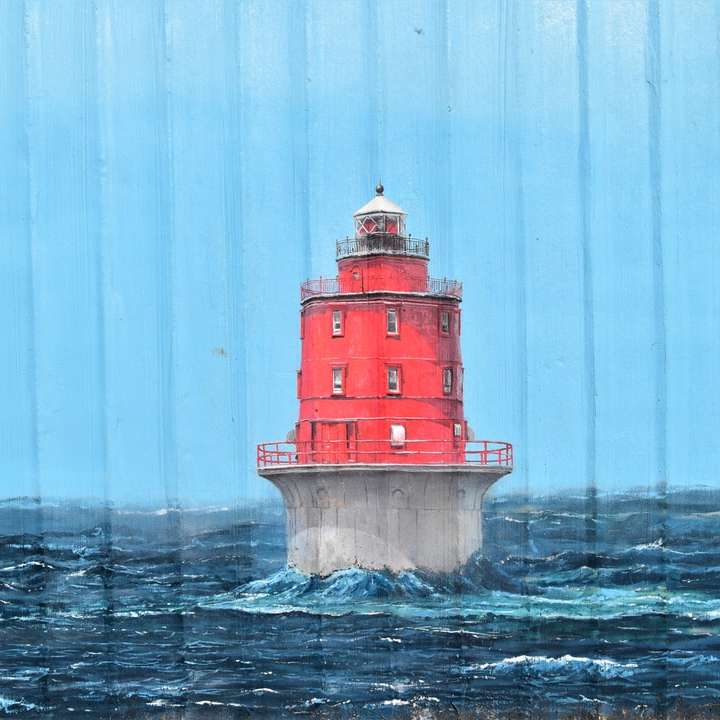 昼間の水域の赤と白の灯台 オンラインパズル
