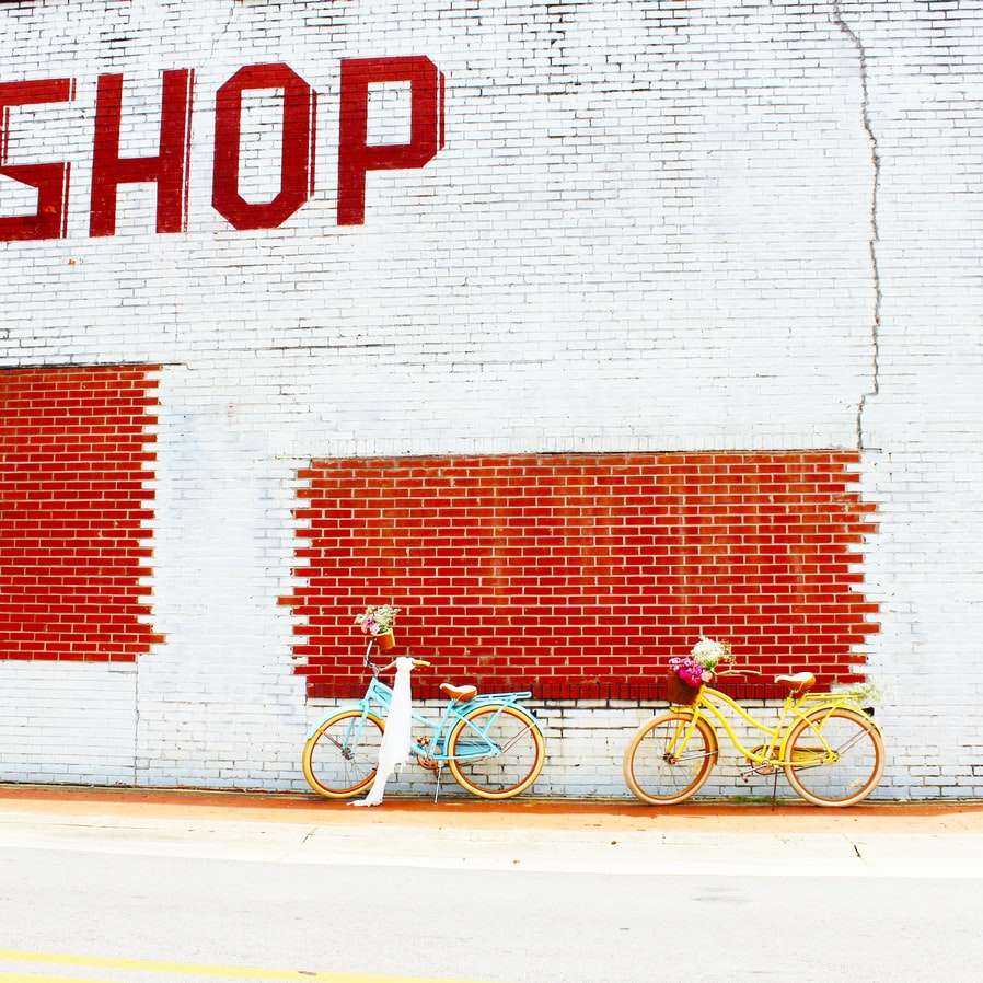 white bicycle parked beside white wall online puzzle