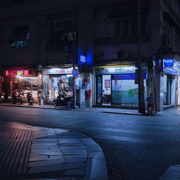 people walking on sidewalk during night time sliding puzzle online