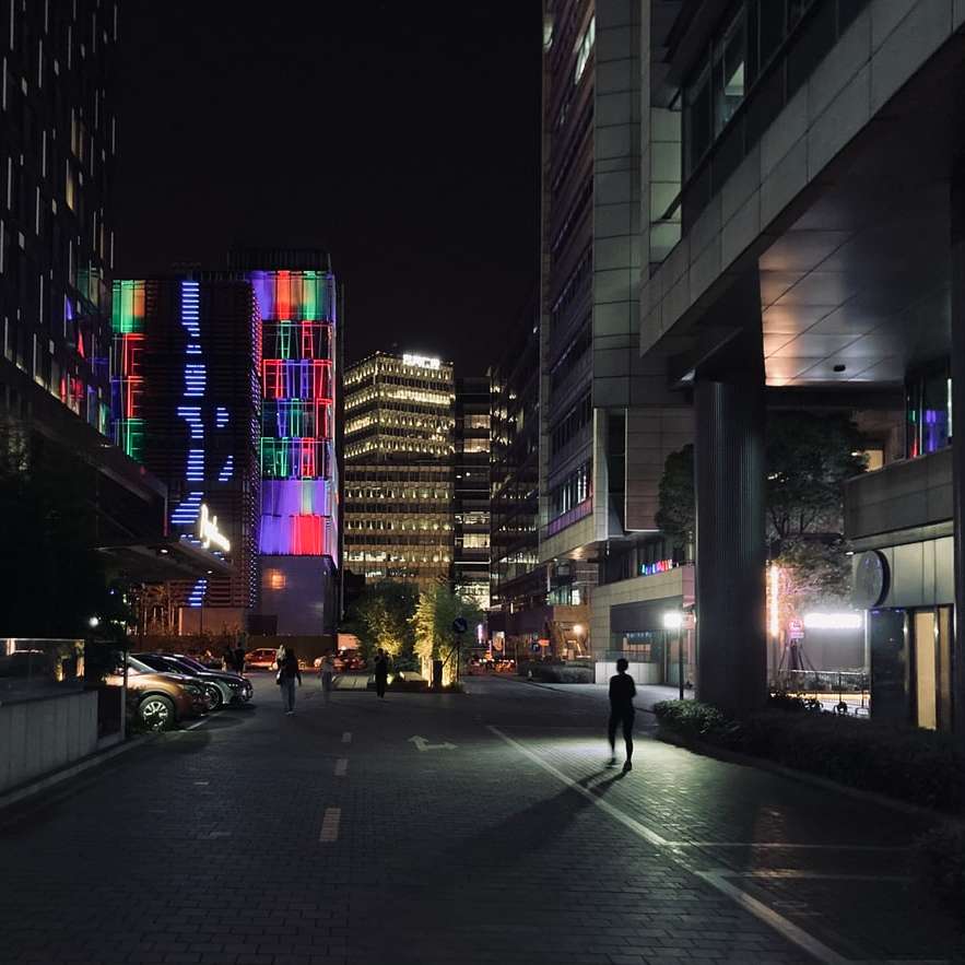 people walking on sidewalk near high rise buildings online puzzle