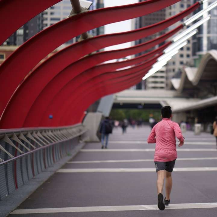 man in red t-shirt running on the bridge sliding puzzle online