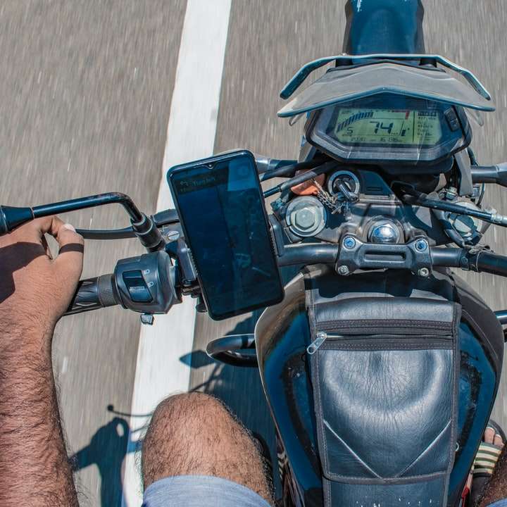 черно-синий мотоцикл припаркован на сером тротуаре онлайн-пазл