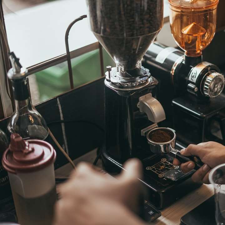 Person, die Kaffee auf klarem Glasbecher gießt Online-Puzzle