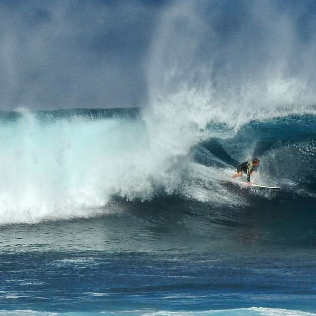 Muž surfování na mořské vlny během dne online puzzle