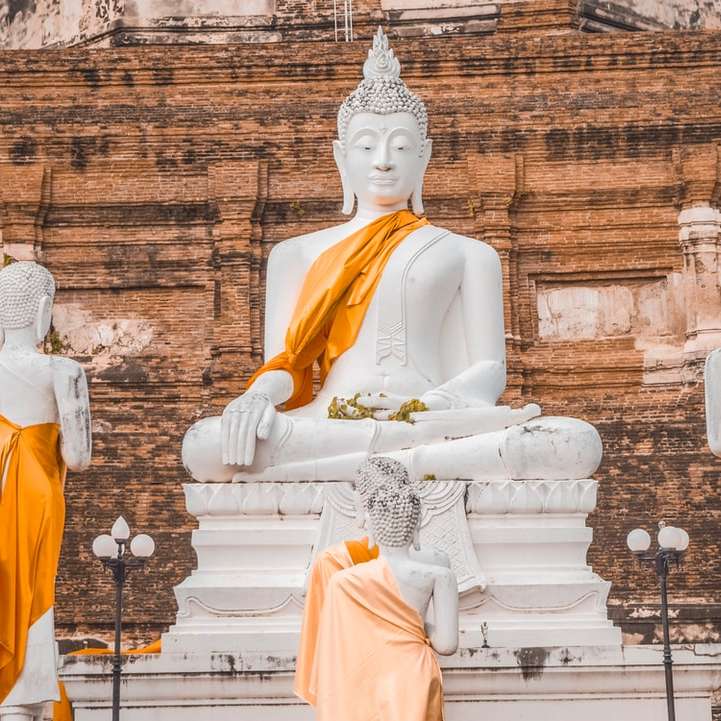 Vit betong Buddha staty under dagtid glidande pussel online
