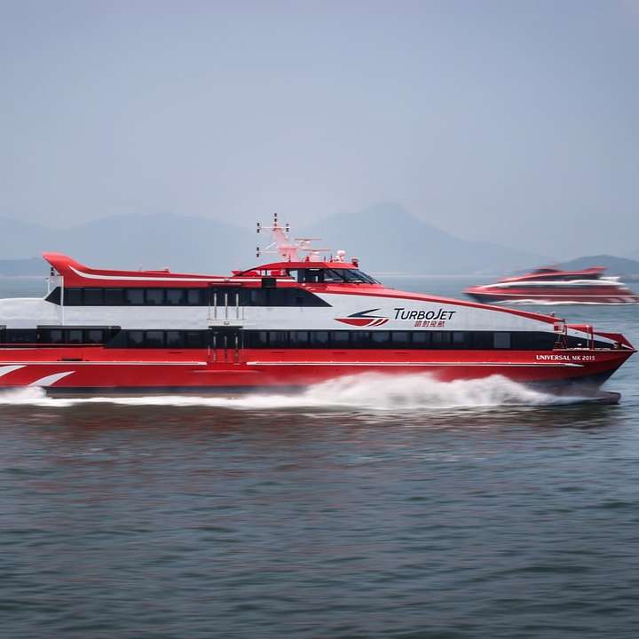 red and white passenger boat on water during daytime online puzzle