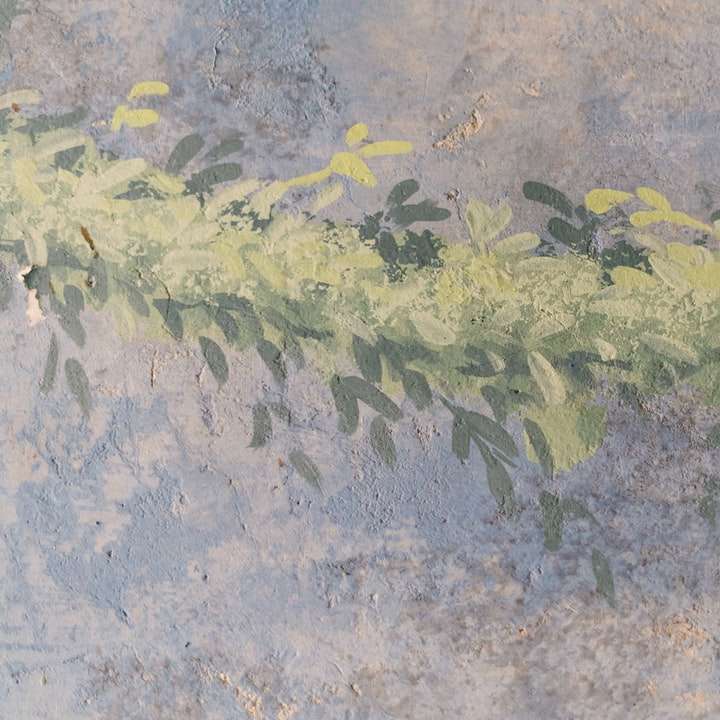 Gröna och gula löv på grått betonggolv glidande pussel online