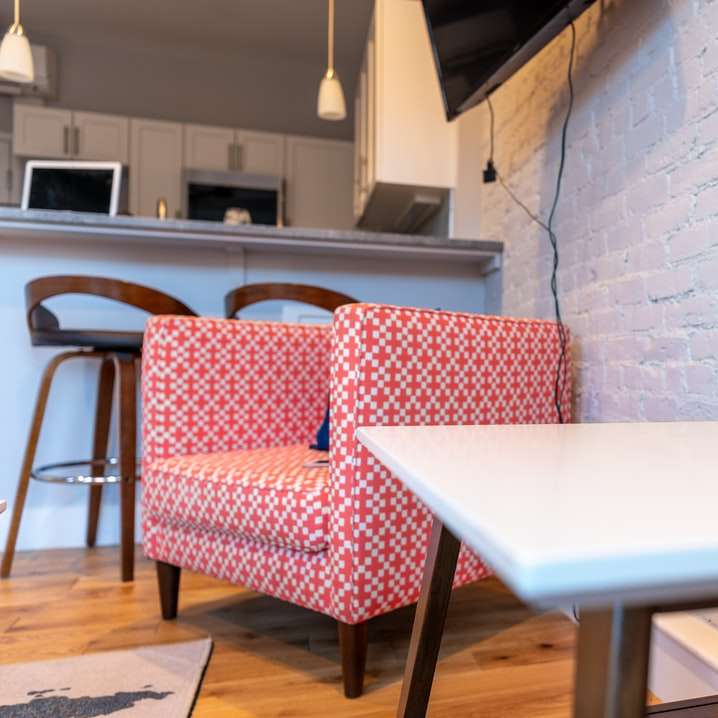 Червен и бял диван близо до бяла маса онлайн пъзел