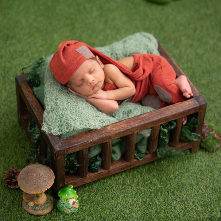 baby in red and white stripe onesie lying sliding puzzle online