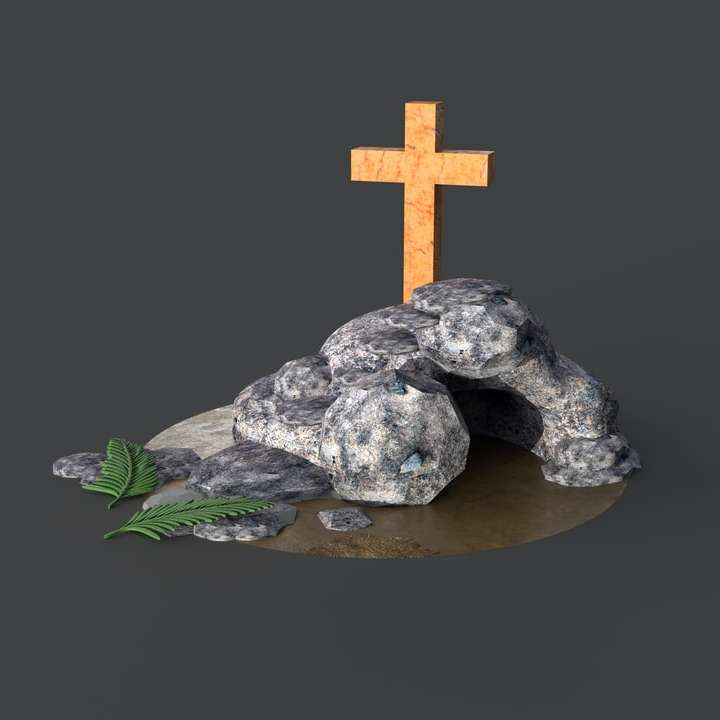 Šedý kamenný kříž na hnědý dřevěný kulatý stůl online puzzle