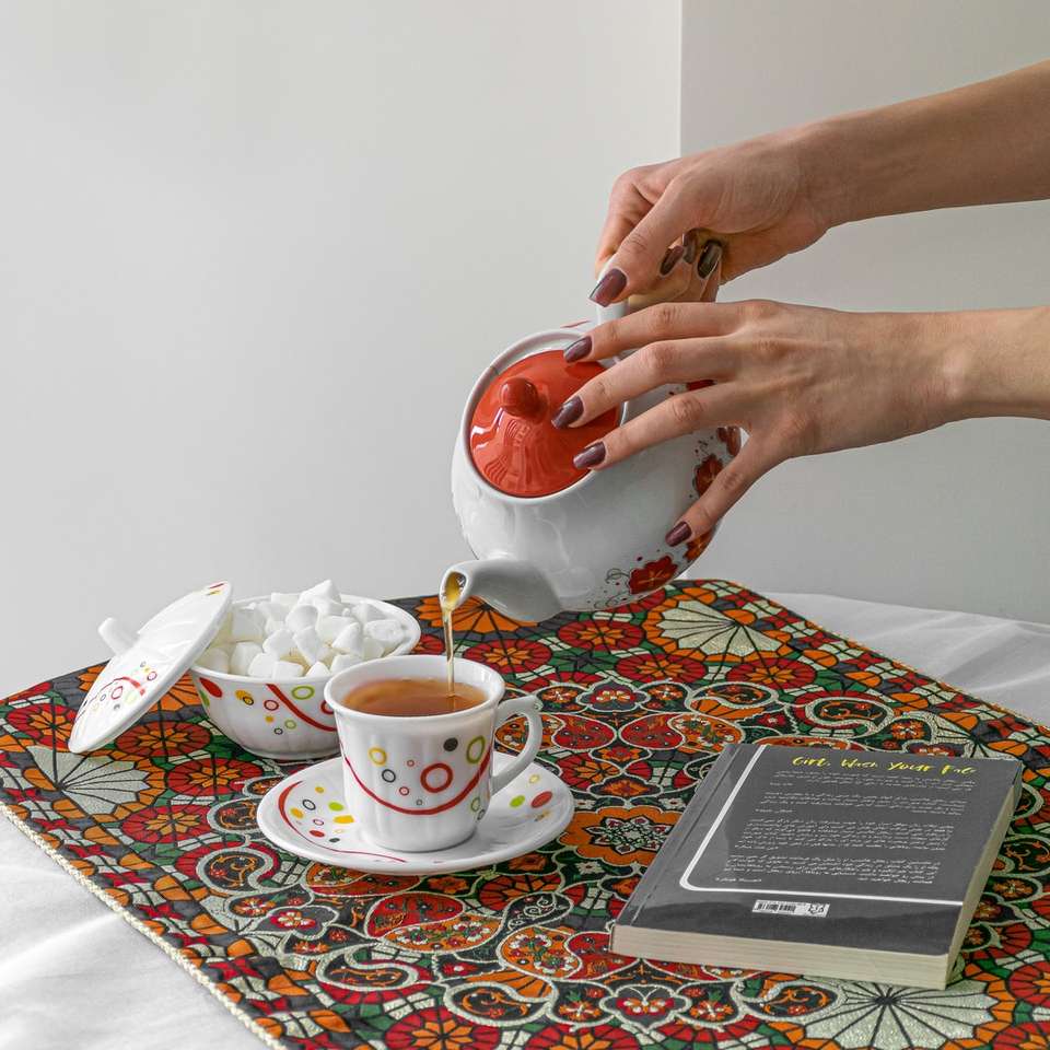 person holding red ceramic mug online puzzle