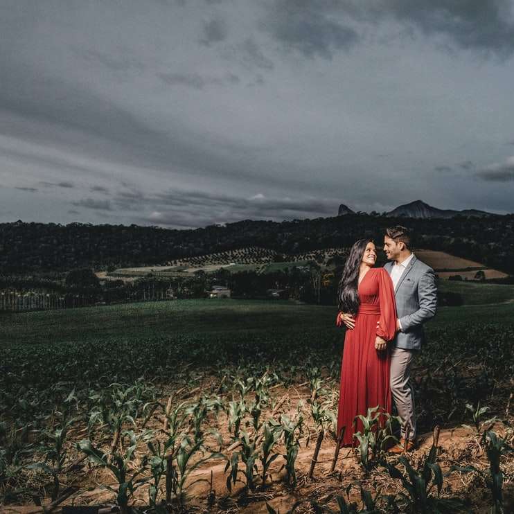 Mann und Frau, die auf braunen Grasfeld nahe Körper stehen Schiebepuzzle online