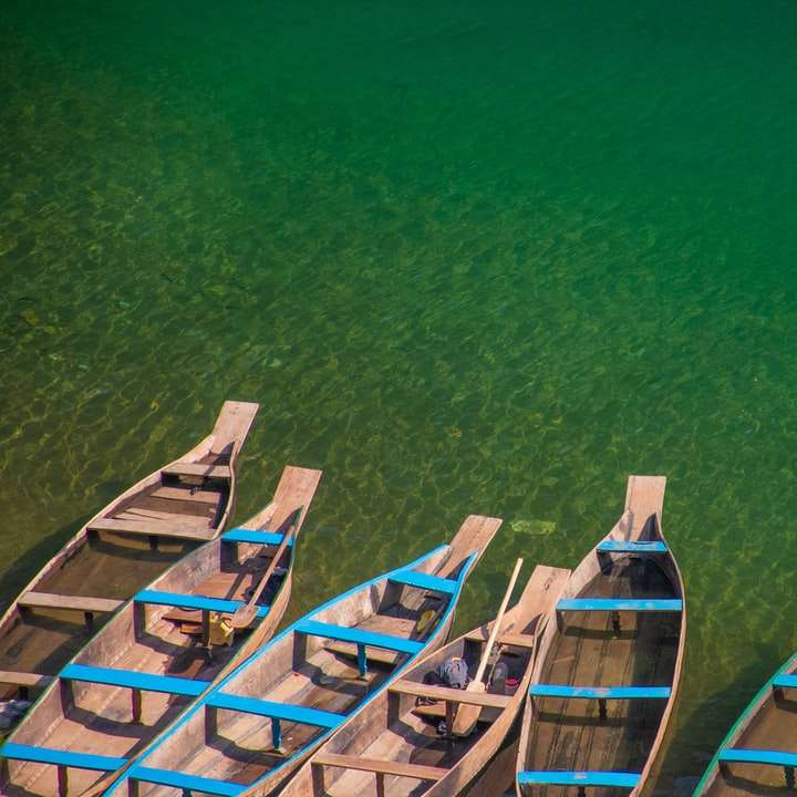 Niebieska i brązowa drewniana łódź na zielonej wodzie puzzle online