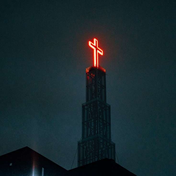 lighted cross on top of building during night time sliding puzzle online