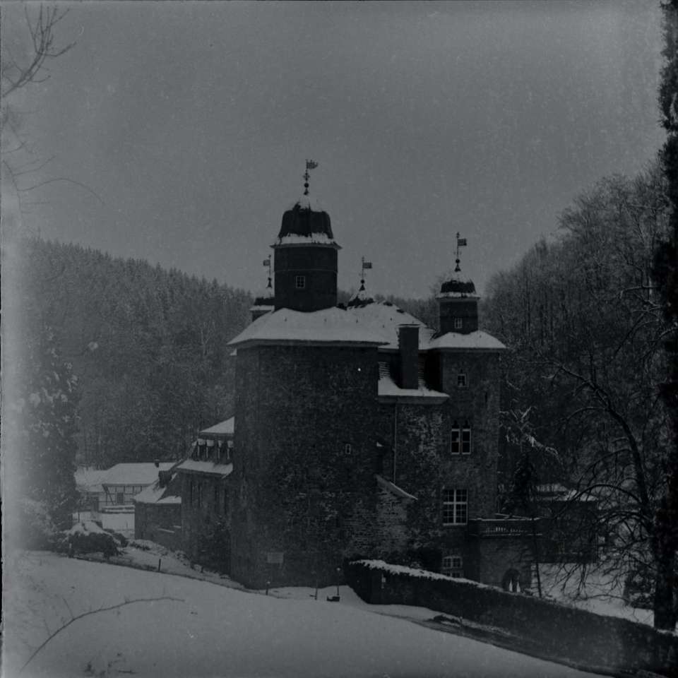 black concrete building on snow covered ground online puzzle