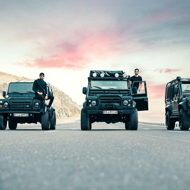 2 men and woman riding on black jeep wrangler sliding puzzle online