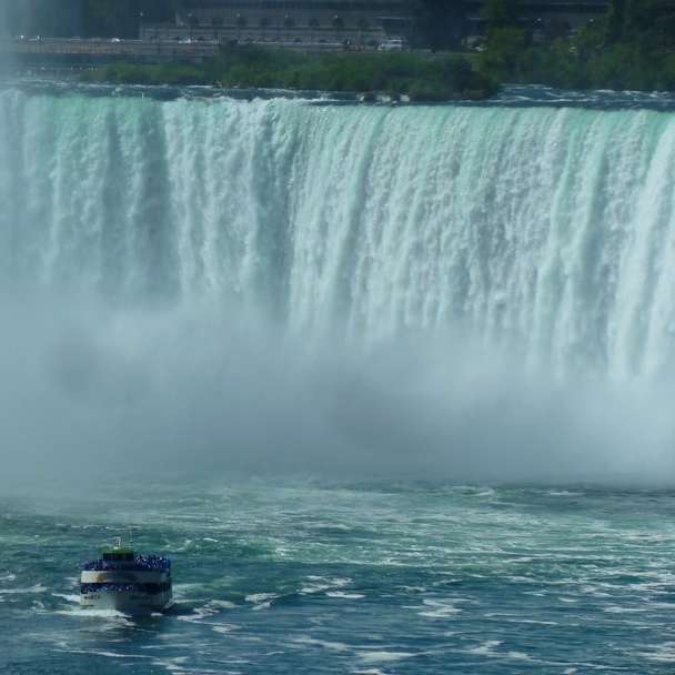 blue inflatable boat on water falls during daytime sliding puzzle online
