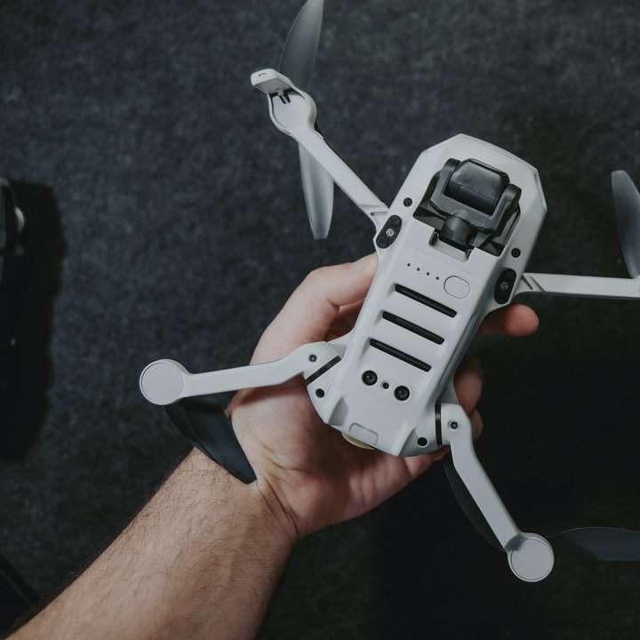 black and gray drone on persons hand online puzzle