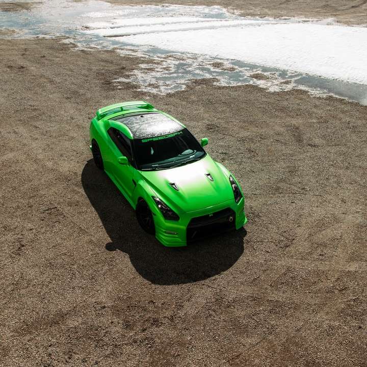 green car on beach during daytime sliding puzzle online