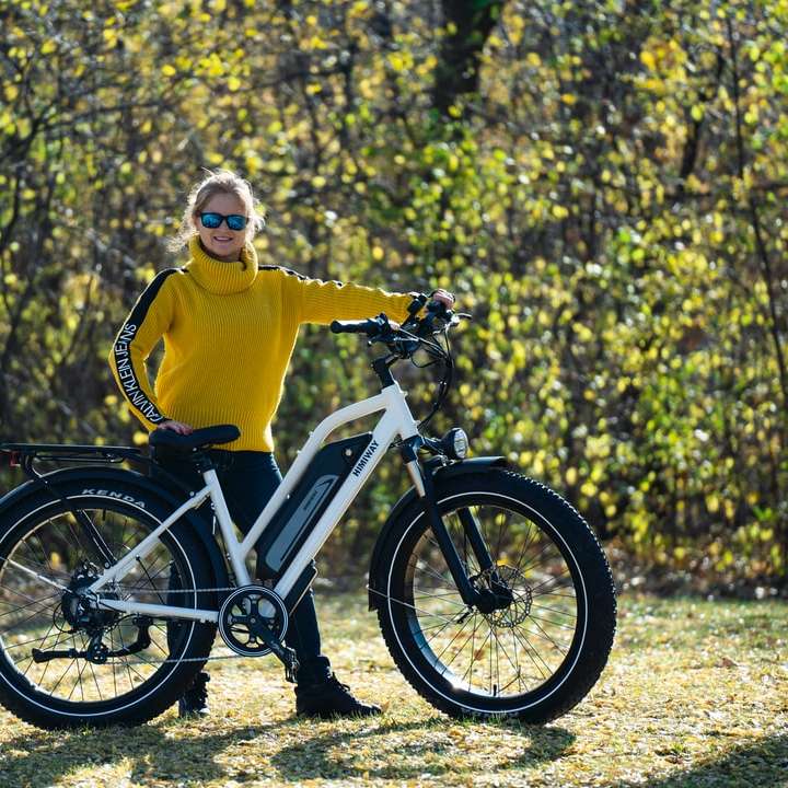 man in yellow hoodie riding white and black bicycle online puzzle