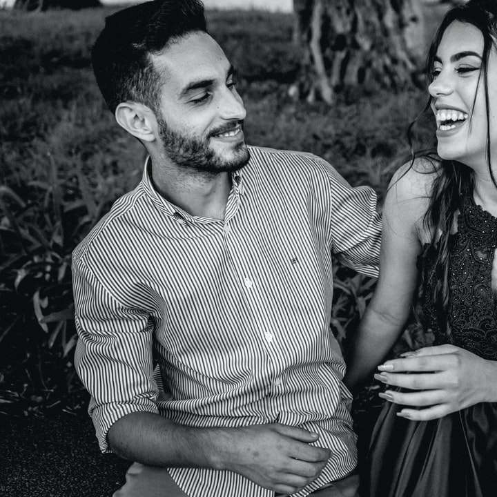man and woman smiling in grayscale photography sliding puzzle online
