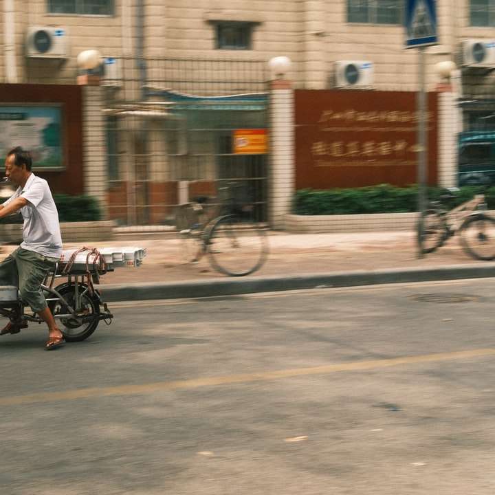 Mann im weißen Hemd, der auf schwarzem Fahrrad unterwegs ist Schiebepuzzle online