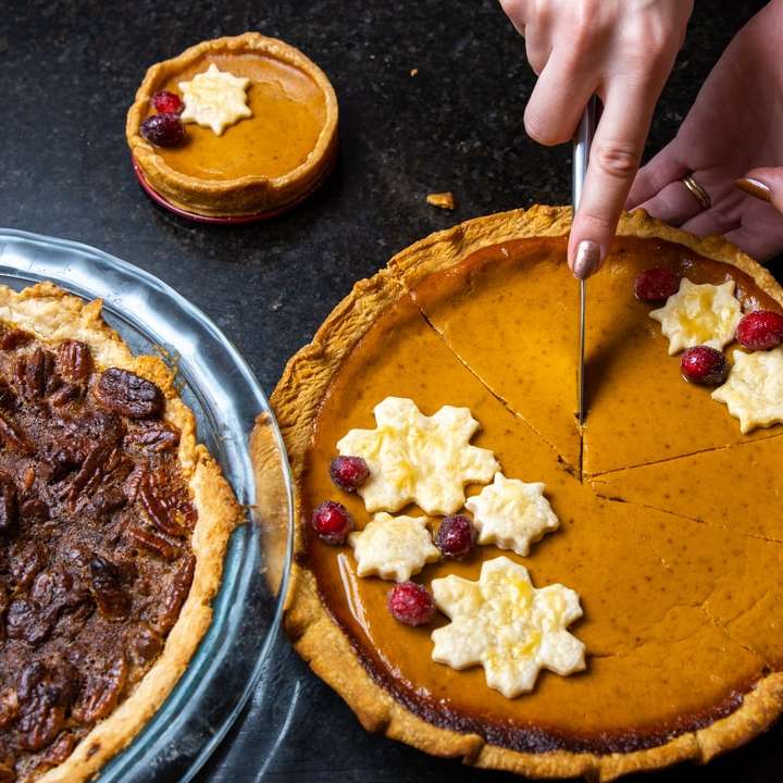 person slicing pie on stainless steel tray online puzzle