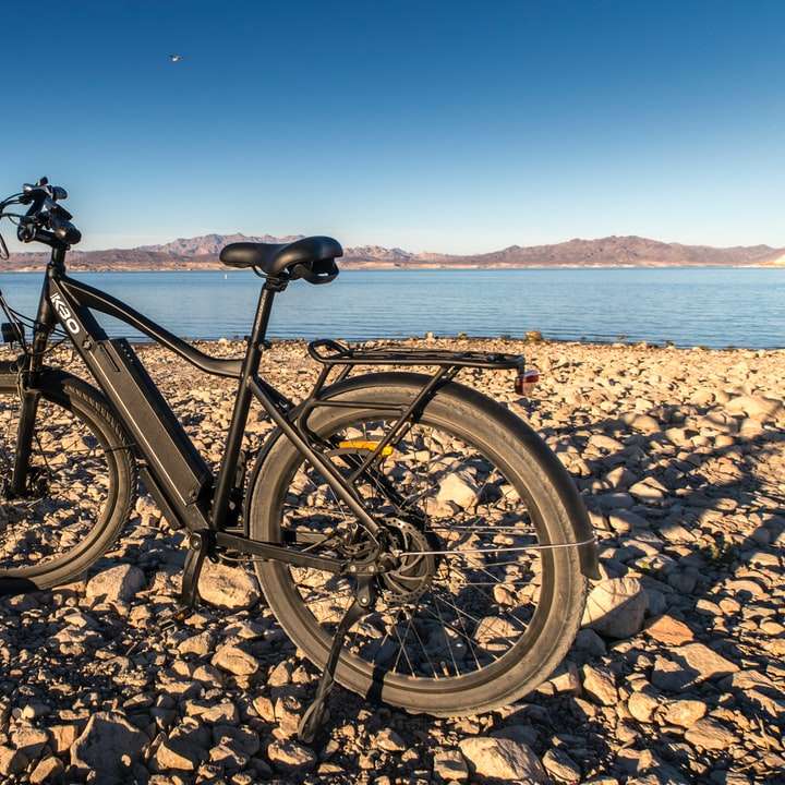 black mountain bike on brown sand during daytime online puzzle