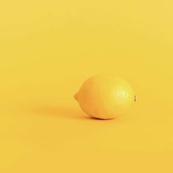 fruta limão amarela na superfície amarela puzzle online