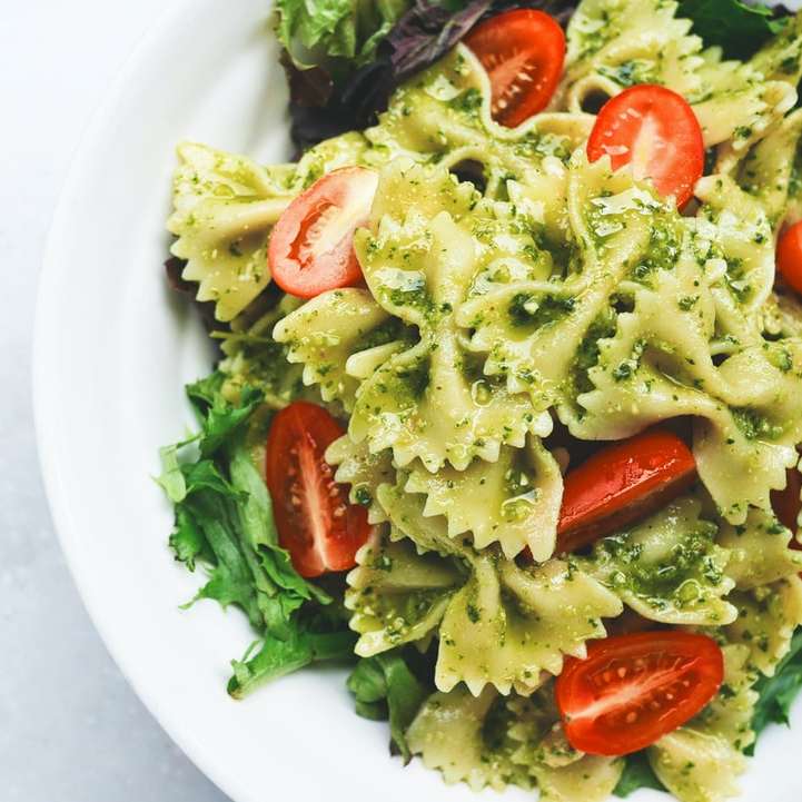 Pesto pasta with sliced tomatoes served sliding puzzle online