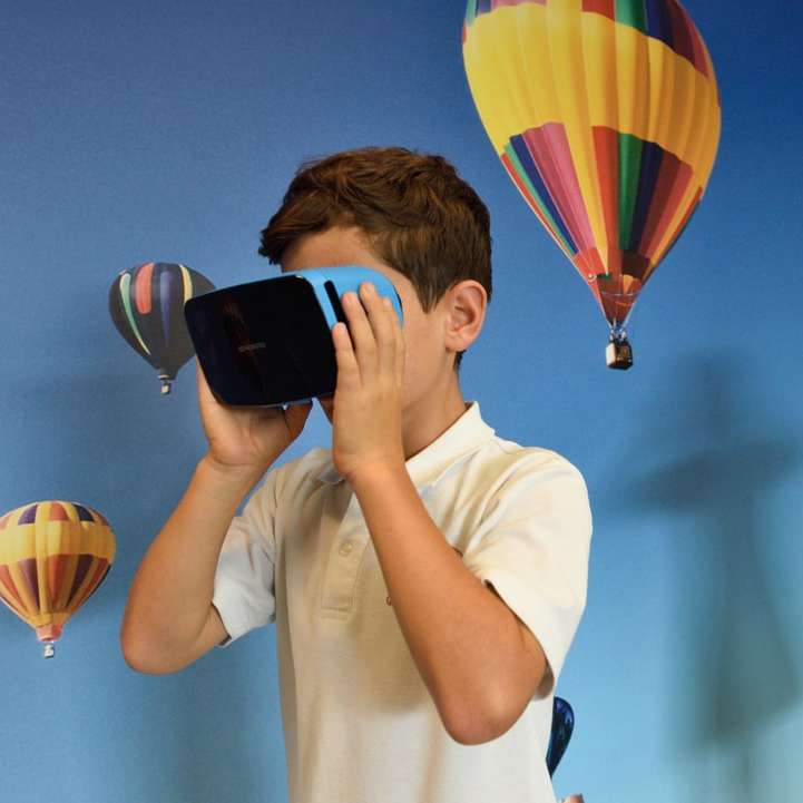 boy and girl uses VR goggles sliding puzzle online