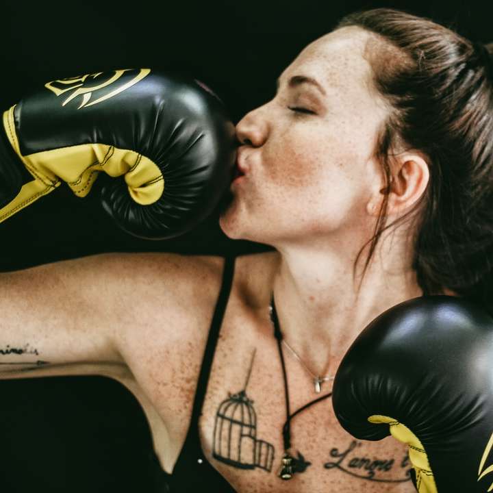 woman kissing black leather boxing gloves sliding puzzle online