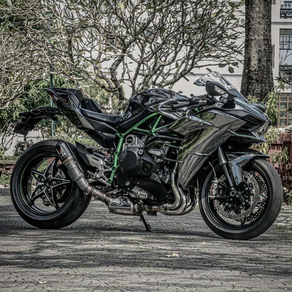 black and green sports bike parked on gray concrete road online puzzle