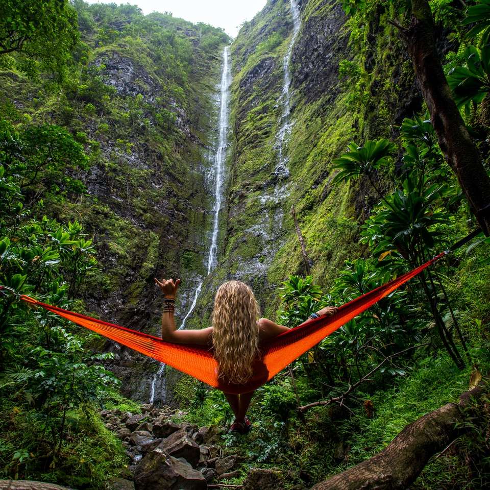 woman on hammock facing waterfalls sliding puzzle online