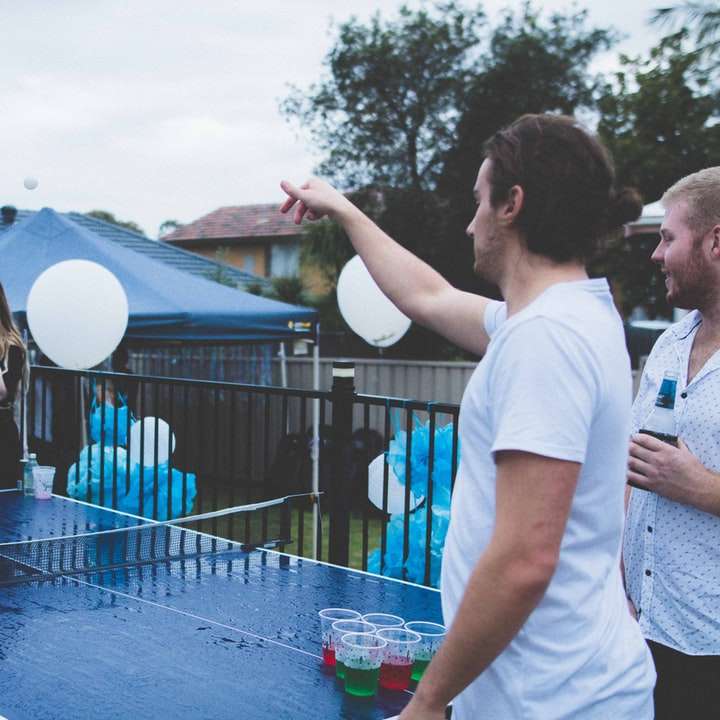 woman versus man playing beer pong under cloudy sky sliding puzzle online