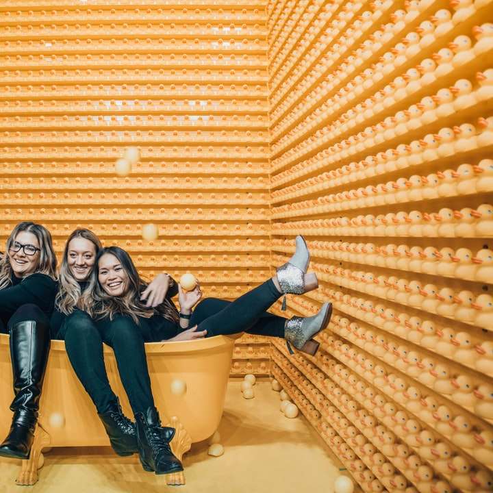 three women sitting inside bathtub sliding puzzle online