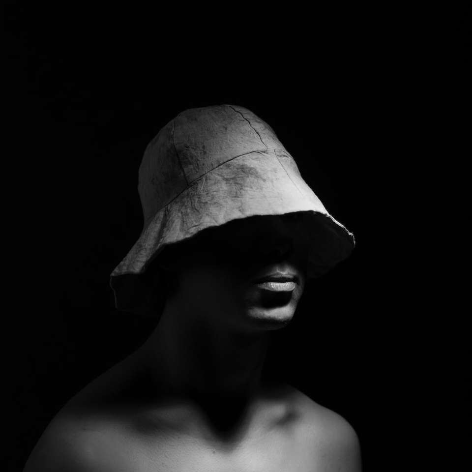 grayscale photo of topless man wearing bucket hat online puzzle